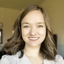 a close up of a woman 's face with a smile on her face .