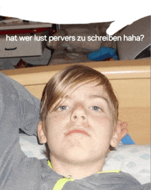 a young boy laying on a bed with the words hat wer lust pervers zu schreiben haha