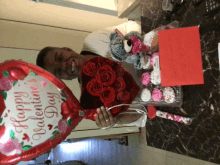 a man holding a heart shaped balloon that says happy valentines day