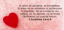 a red heart is on a pink background with a bible verse from 1 corinthians 13 4 5