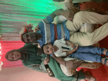 a family poses for a picture while sitting on a chair