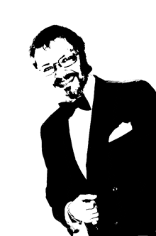 a man in a tuxedo with glasses and a bow tie