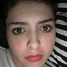 a close up of a woman 's face with a zebra print background .