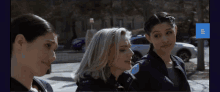 three female police officers are standing next to each other and one of them has a patch on her shoulder that says ear