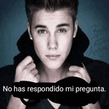 a picture of justin bieber with the words no has respondido mi pregunta below him