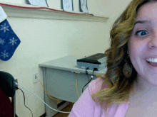 a woman sitting in front of a desk with an epson printer