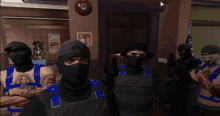 a group of men wearing masks are standing in a room with a fire extinguisher on the wall