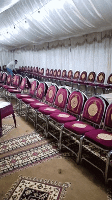 a row of purple chairs with gold embroidery on them