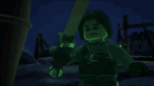 a glow in the dark lego character is holding a green sword in his hand .