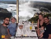 a family sitting at a table in front of a waterfall in niagara falls canada on august 31st 2019