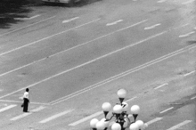 a black and white photo of an empty street with arrows pointing to the right