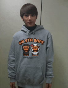 a man wearing a hoodie that says go sta bape on it