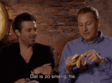 two men are eating bananas and one of them is saying " dat is zo smerig he "