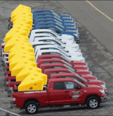 a row of red tundra trucks are parked in a parking lot