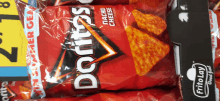 a bag of doritos nacho cheese chips sits next to another bag