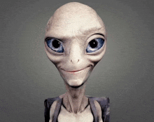 a smiling alien with blue eyes and a gray shirt