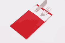 a fork and knife in a red napkin