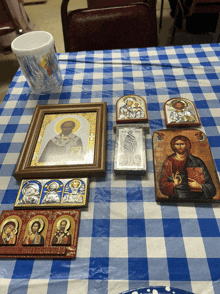 a table with a blue and white checkered tablecloth and icons on it