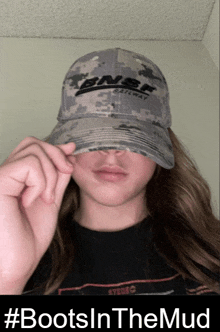 a woman wearing a bnsf railway hat covers her face