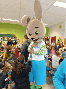 a mascot wearing a white shirt that says pamme on it