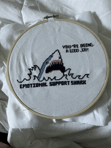 a cross stitch of a shark says you 're doing a good job emotional support shark