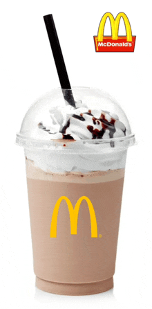 a mcdonald 's drink with whipped cream and a straw