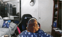 a person wearing a helmet and headphones sits in a chair that says aracing