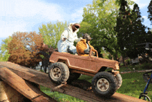 a toy jeep is driving down a wooden hill