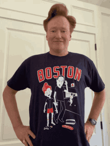 a man wearing a boston t-shirt with cartoon characters on it