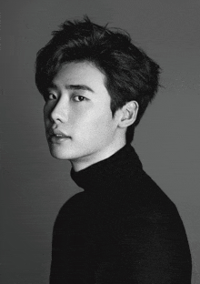 a black and white photo of a young man with a turtleneck