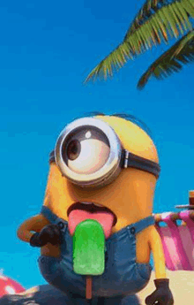 a minion is sticking out his tongue while eating an ice cream popsicle