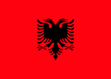 a red background with a black eagle with two heads