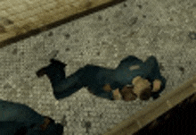 a man in a police uniform is laying on the floor .