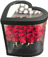 a heart shaped box filled with red roses has a label that says happiness box