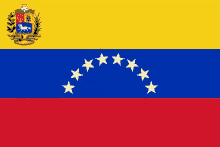 the flag of venezuela has a coat of arms with a horse and shield on it .