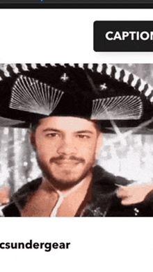 a man with a beard is wearing a black sombrero .