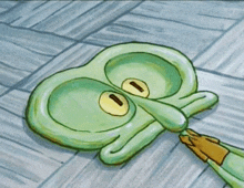 squidward from spongebob squarepants is laying on the floor with a pencil in his mouth .