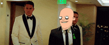 a man in a tuxedo with a cartoon face on his head