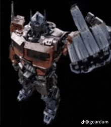 a robot is giving the middle finger with its arms outstretched on a black background .