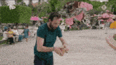 a man in a green shirt is standing in front of a display of stuffed animals and a sign that says avro tro