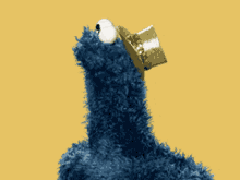 cookie monster from sesame street wearing a crown on his head