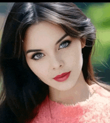 a close up of a woman 's face with blue eyes