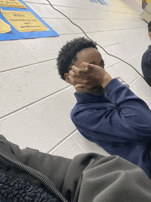 a boy covering his face in front of a sign that says growth