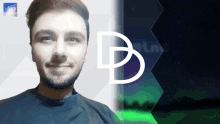 a man with a beard is smiling in front of a logo that has the letter b