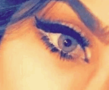 a close up of a woman 's eye with eyeliner .