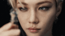 a close up of a woman 's face with a feather in her hair