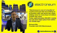 a man in a suit stands in front of a sign that says electroneum