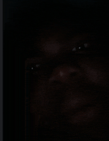 a close up of a person 's face with a dark background