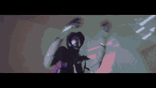 a man wearing a mask and a hoodie is dancing in a room with a purple and green background .