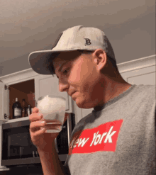 a man wearing a hat and a new york shirt